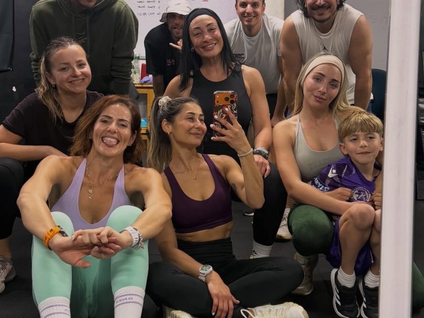 Members taking a mirror selfie together after a workout